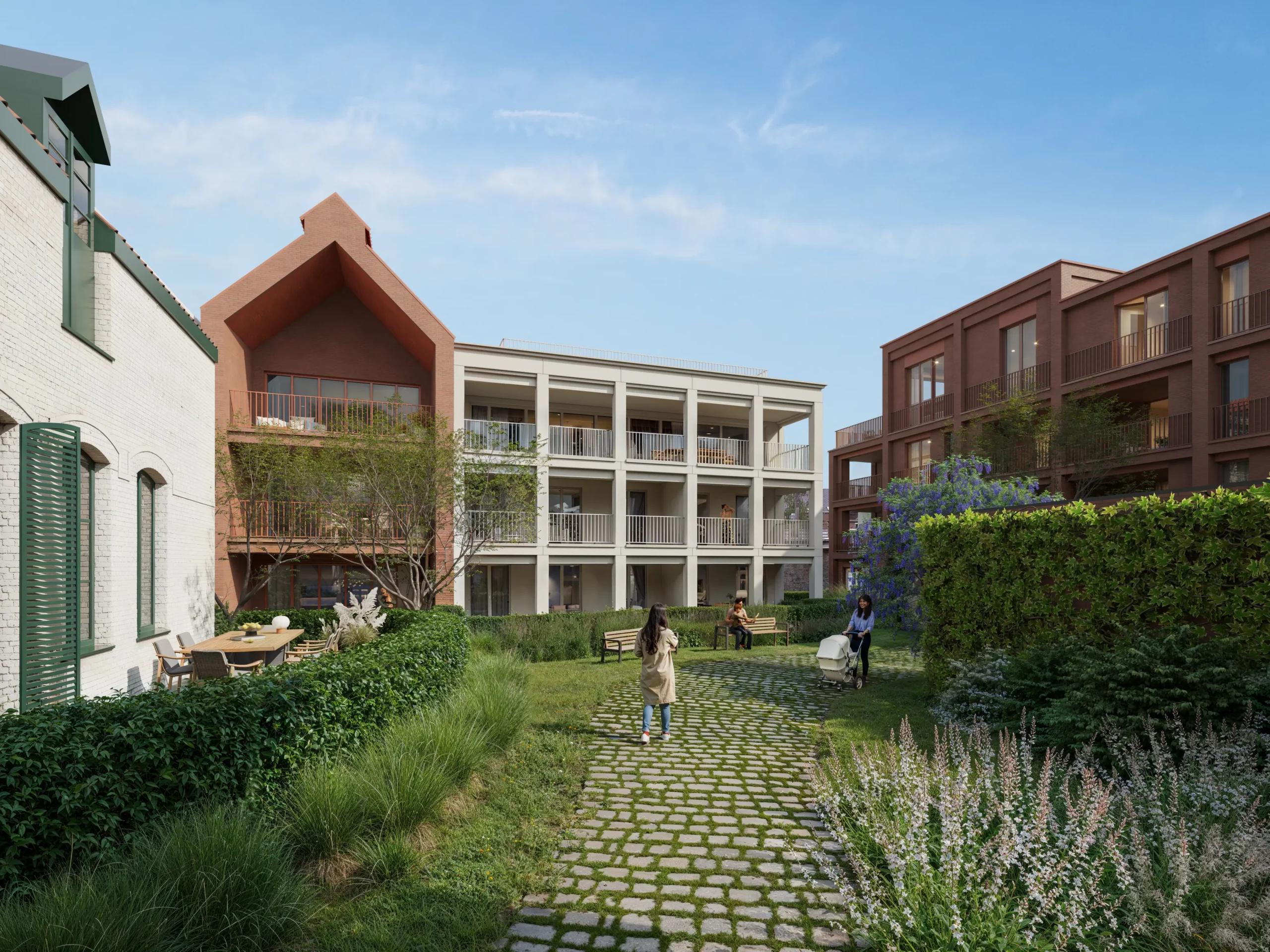 Groene binnentuin met kasseipad tussen de gebouwen van Residentie De Brouwerij in Zottegem